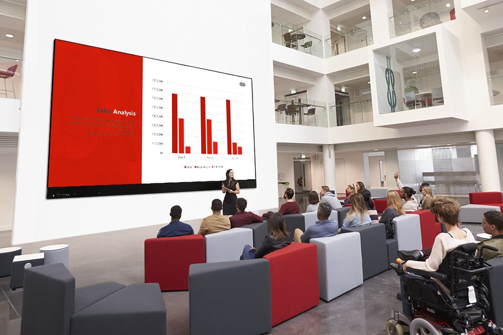 Students at a lecture in the atrium of a modern university
